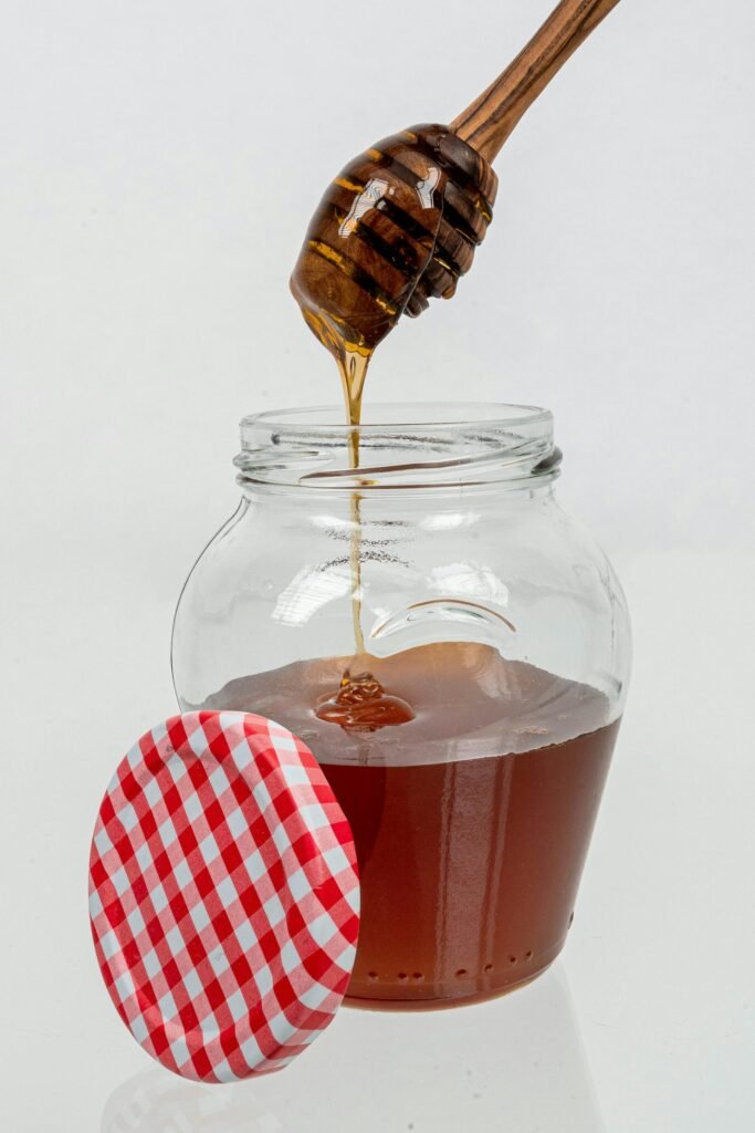 alt="Image of honey in a big jar"