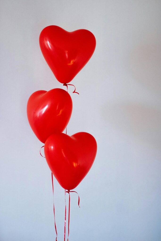 alt="image of heart shaped balloons"