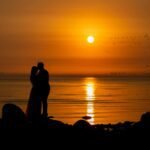 alt="man and woman sunset"