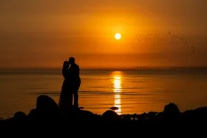 alt="man and woman sunset"