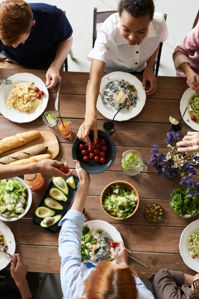 alt="Image of people sharing meal"