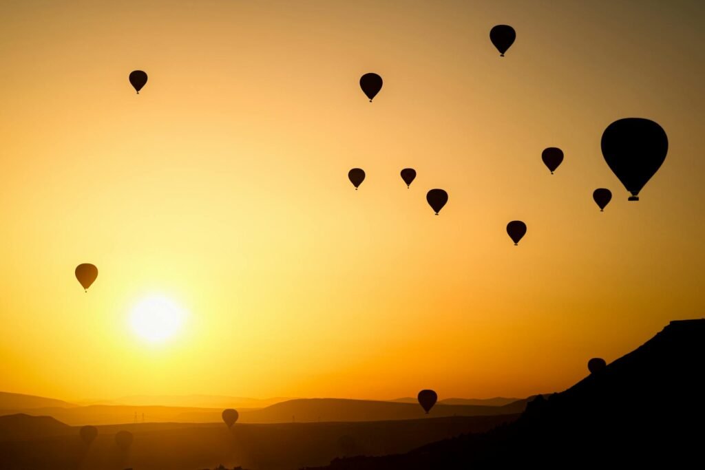 alt="Image of Air balloons at sunset"