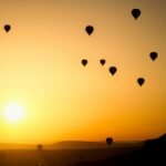alt="Image of Air balloons at sunset"