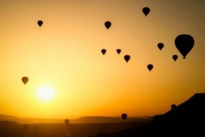 alt="Image of Air balloons at sunset"