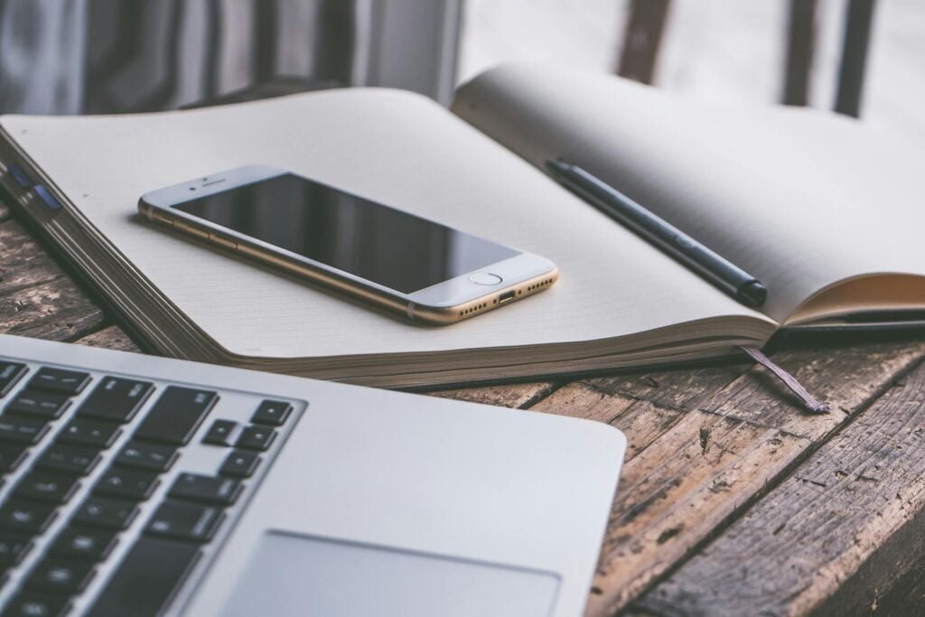 alt="Picture of Laptop smartphone notebook and pen"