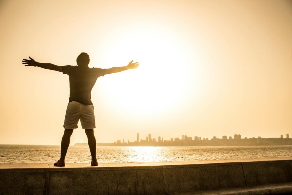 alt="Picture of Man Standing on the Ledge"