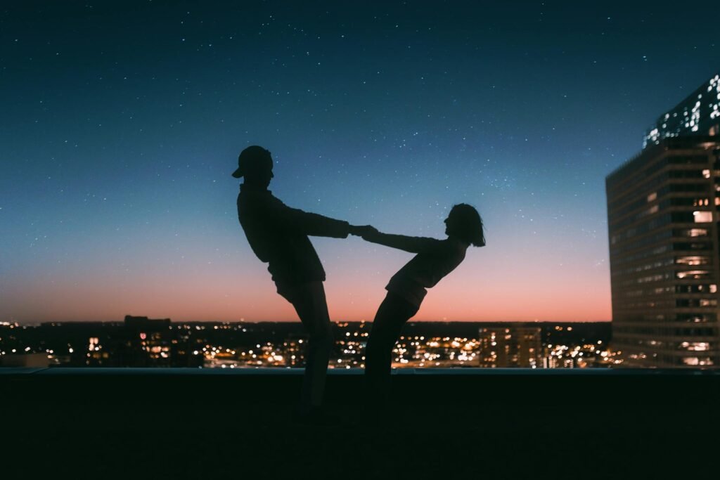 alt="Picture of Man and woman Playing in sunset"