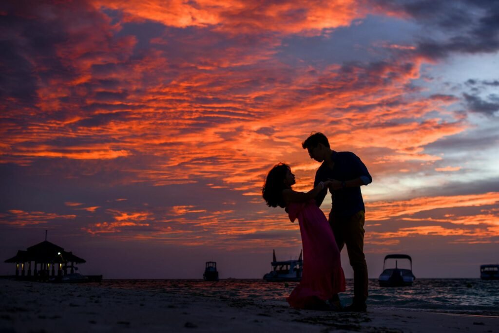 alt="Picture if Man and woman dancing in sunset"