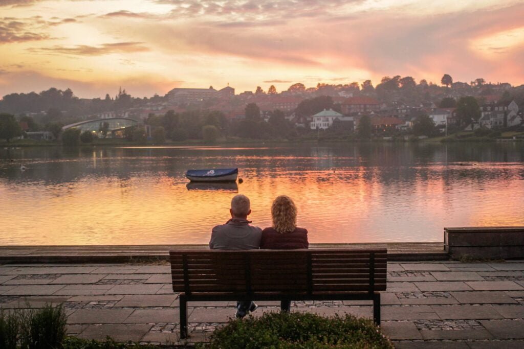 alt="Picture of Man and woman sitting on bench"