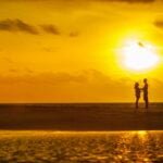 alt="Picture of Man and woman standing in sunset"