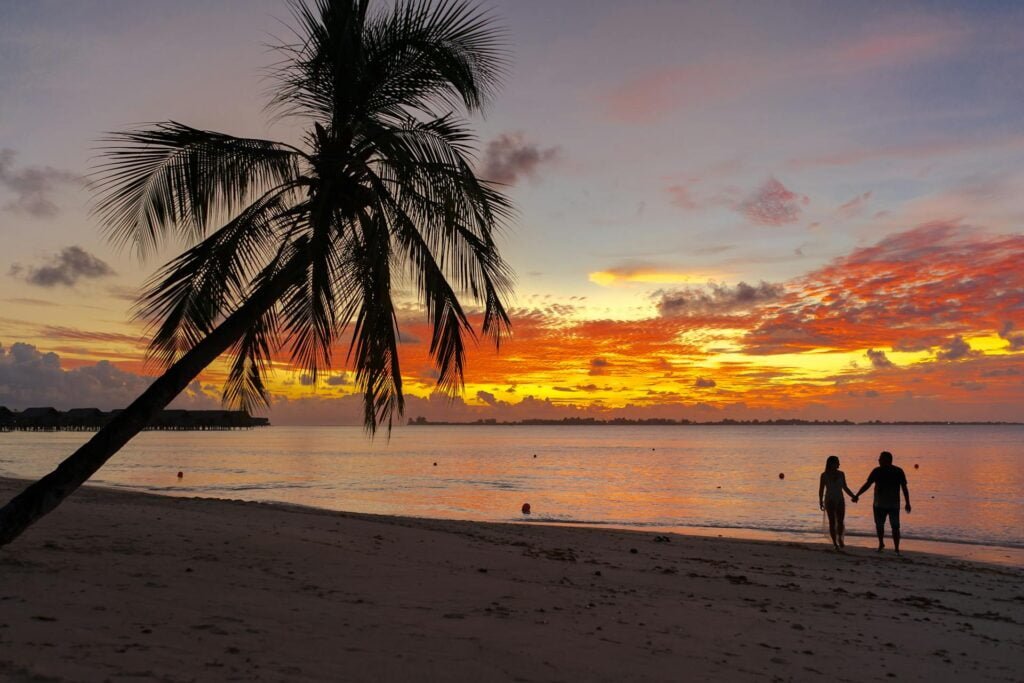 alt="Picture of Man and woman walking in sunset"