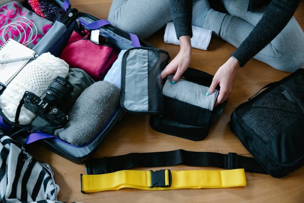 alt="Picture of Person packing clothes"