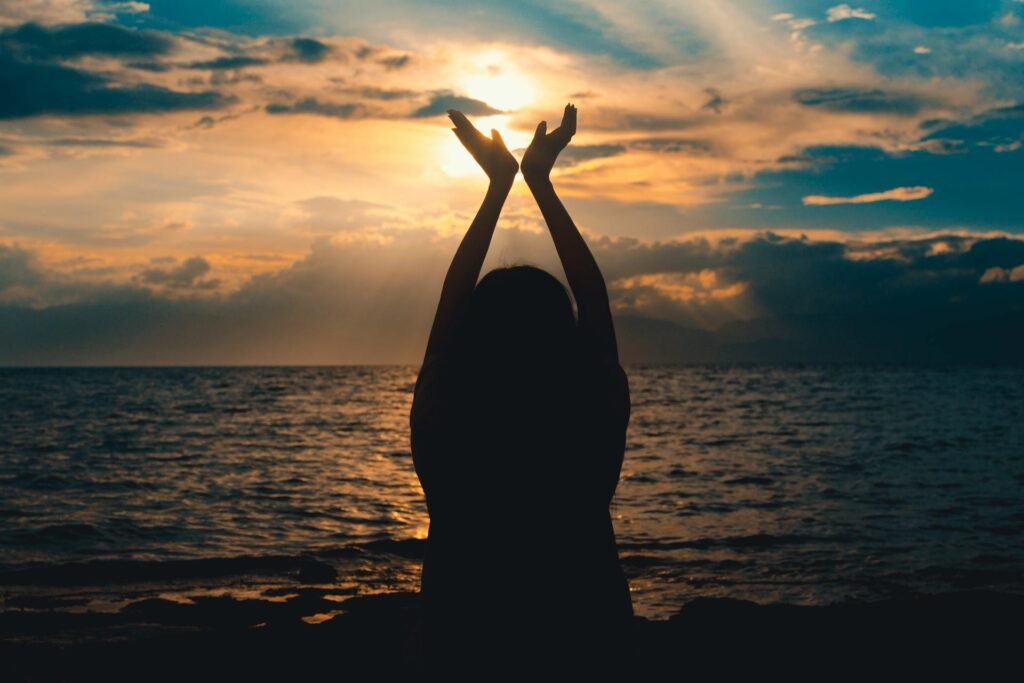 alt="Picture of Person raising hands up"