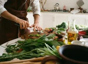 alt="Picture of person cutting vegetables"