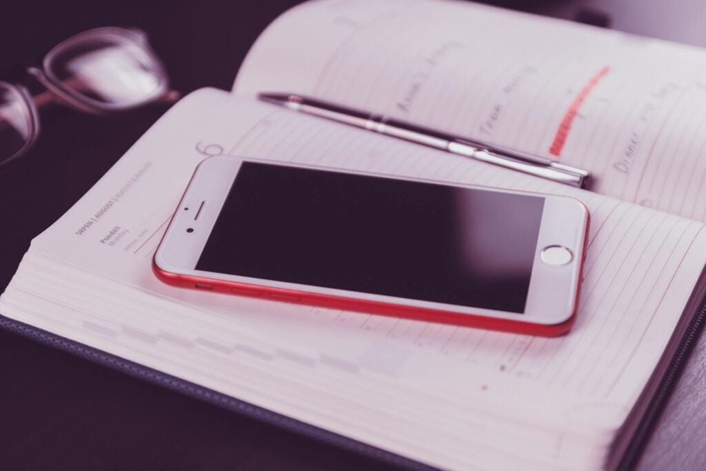 alt="Picture of Smartphone on top of open calendar"