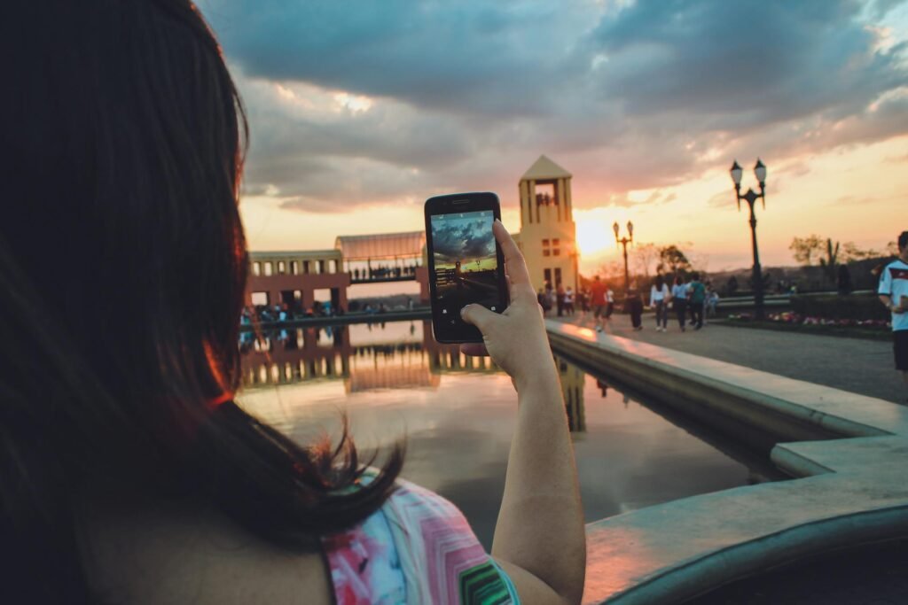 alt="Picture of Woman holding smartphone"