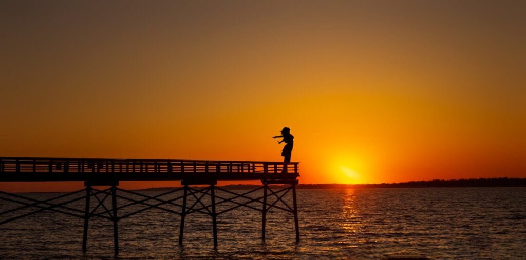 alt="Picture of Woman standing on a dock"