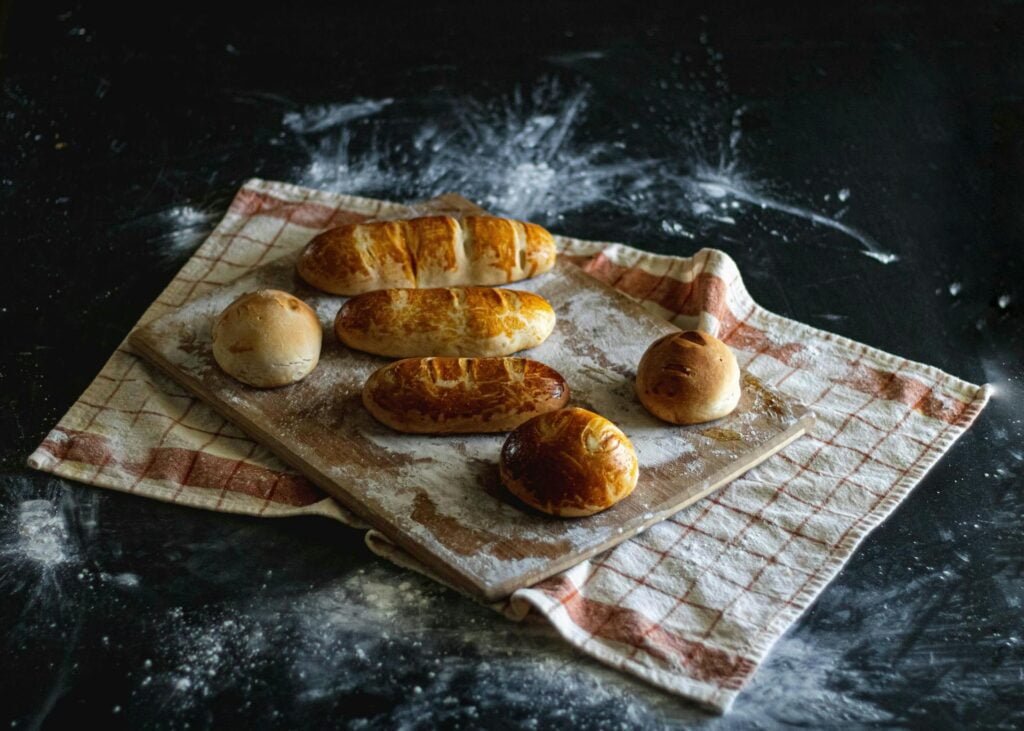 alt="Image of Wooden tray with breads"