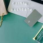 alt=”Image of Bank card on top of open laptop next shopping cart”