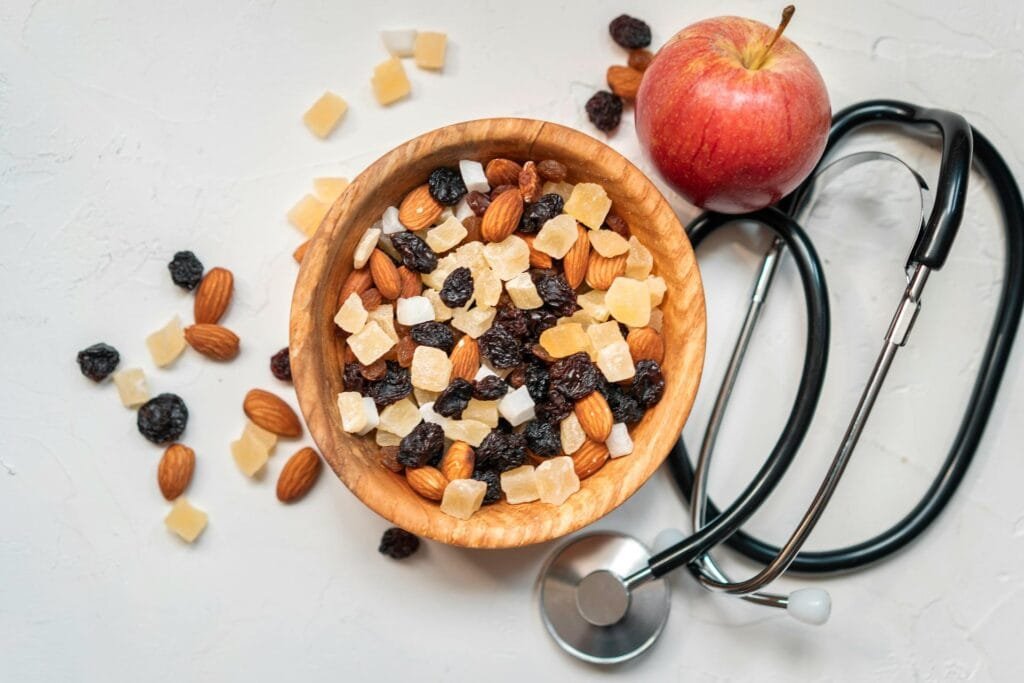 alt="Image of Bowl of nuts dried fruits and stethoscope"