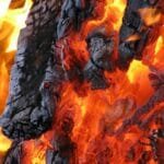 alt=”Image of Burning wood and charcoal”