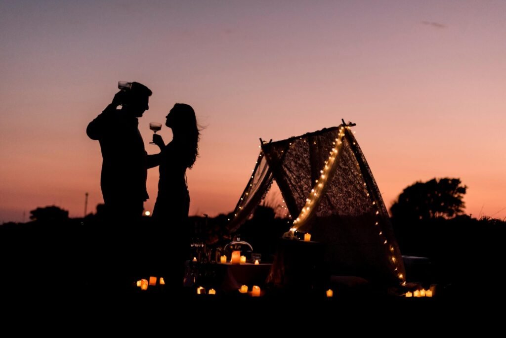 alt=”Image of Couple camping in sunset”