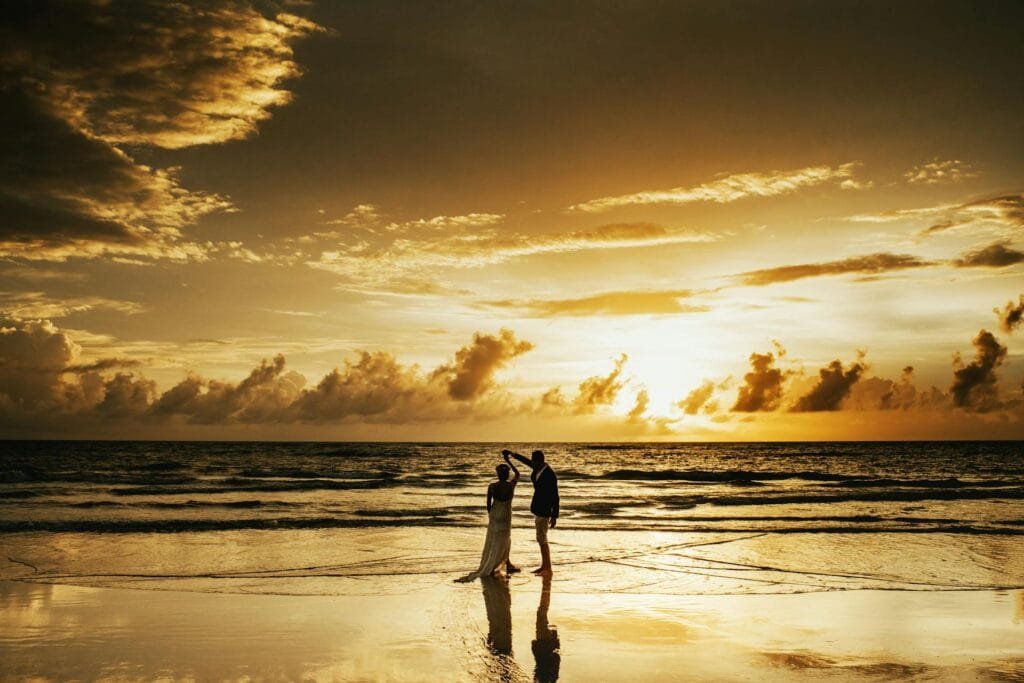 alt=”Image of Couples dancing on the beach”