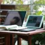 alt=”Image of Laptop smartphone and tablet on a table”