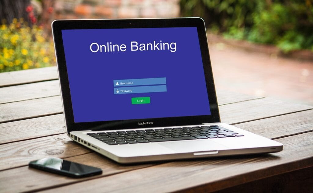 alt="Image of Laptop with online banking on screen"