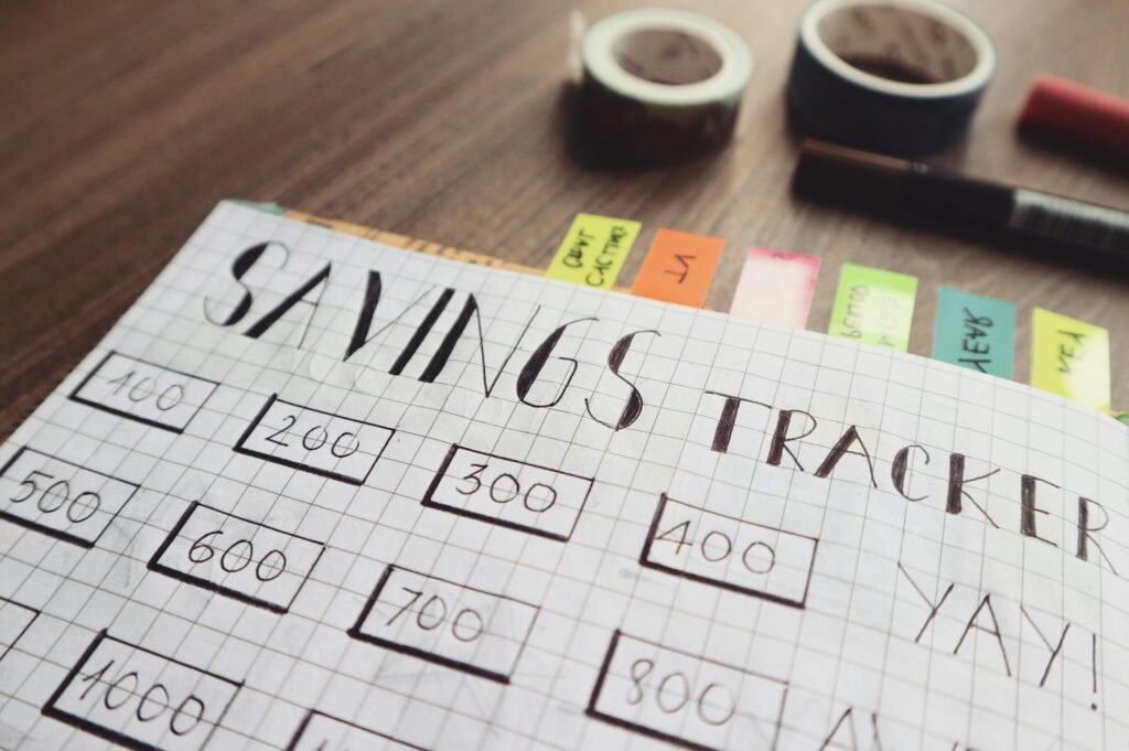 alt="Image of Open notebook with saving tracker in writing"