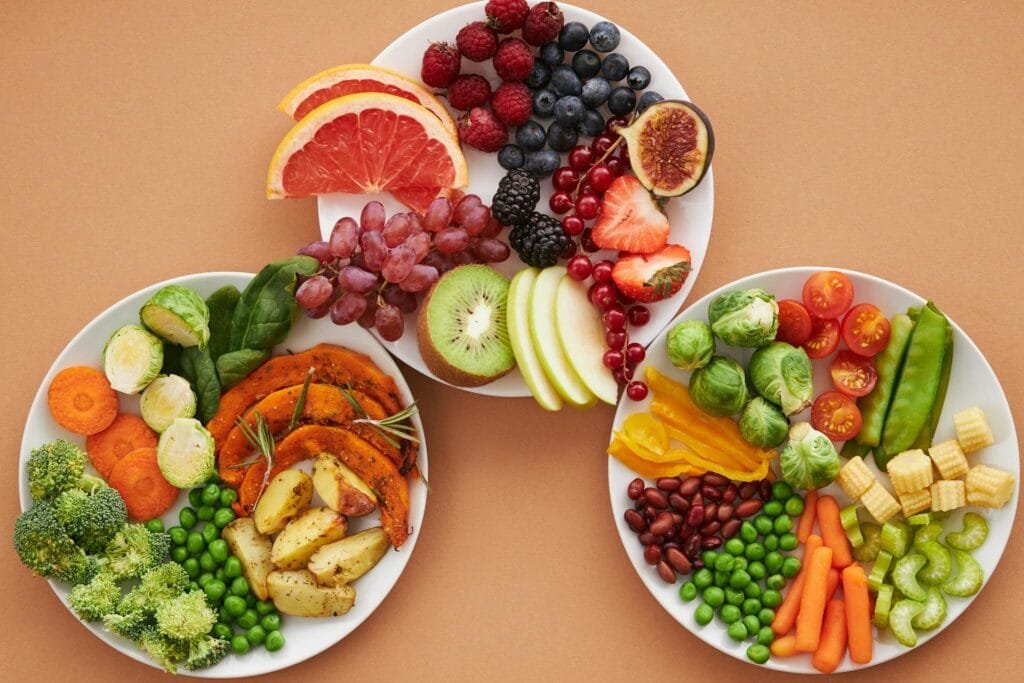 alt="Image of Plates of vegetables and fruits"