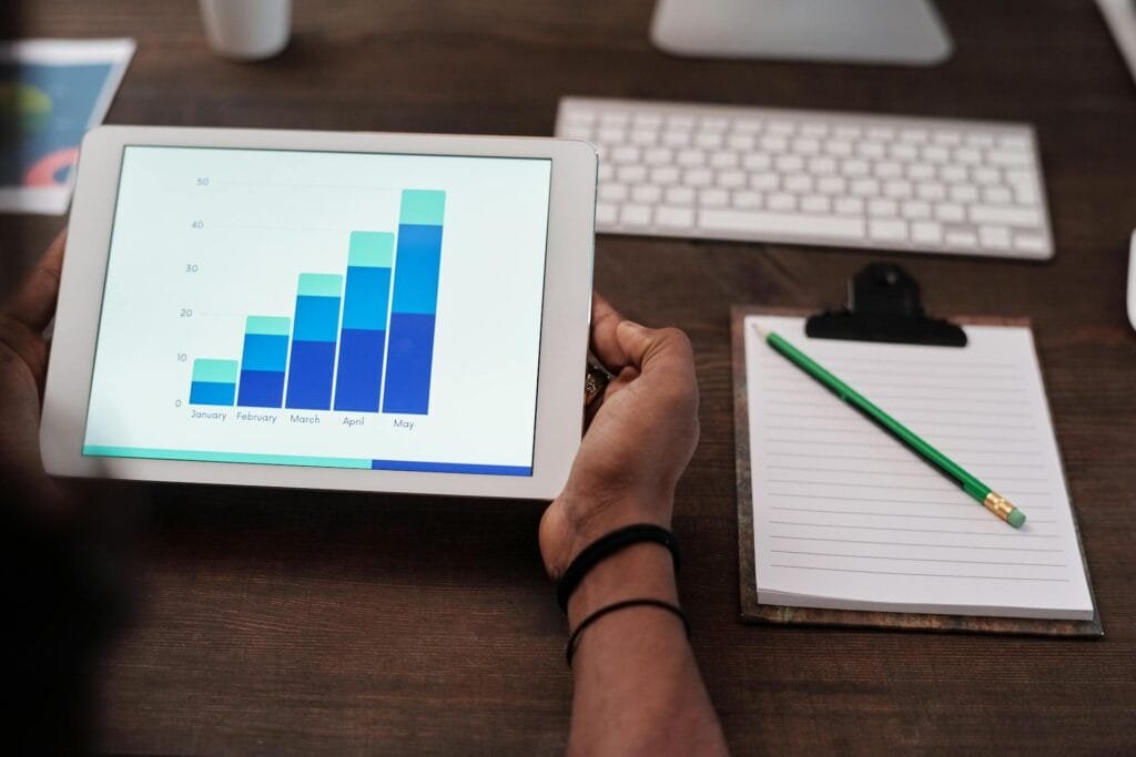alt="Image of Tablet with rising bar graph"