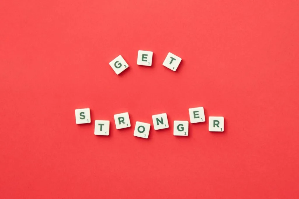 alt=”Image of Tiles with get stronger spelled out”