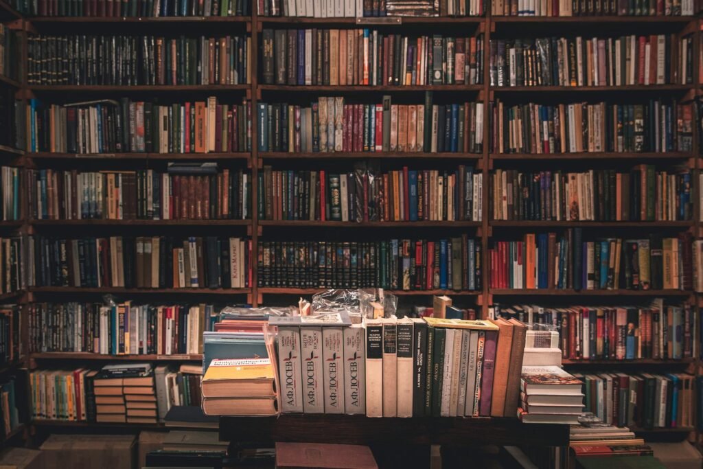 alt=”Image of Books on wooden shelves”