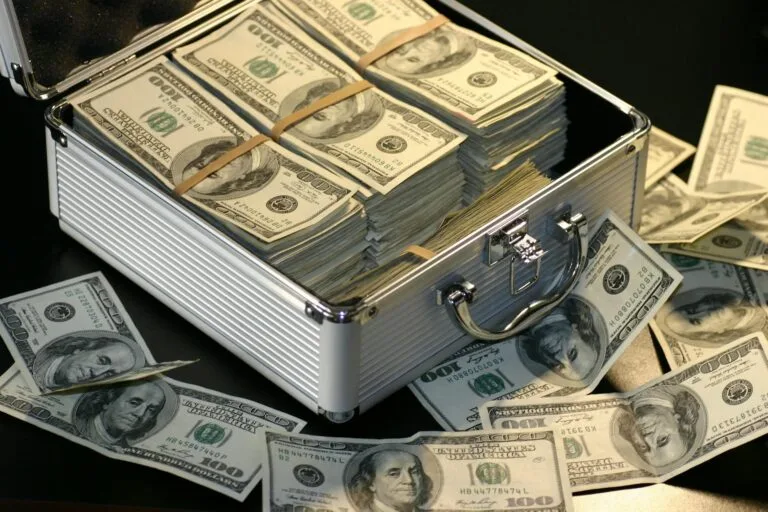 alt=”Image of Gray case with bundles of money”