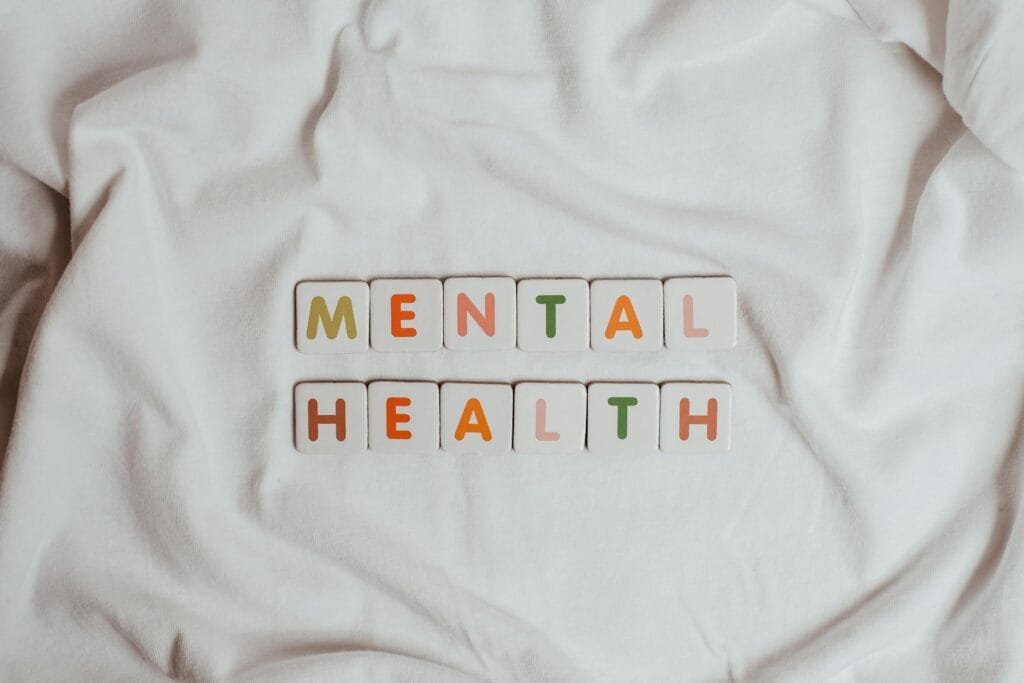 alt=”Image of Tiles spelling mental health”