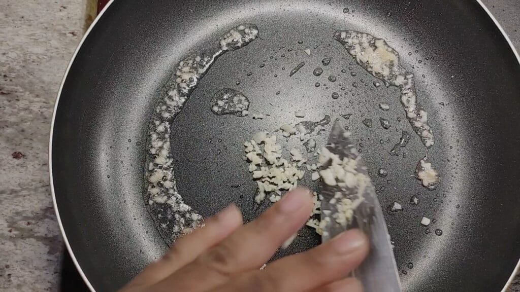 alt="Adding Ginger and Garlic"