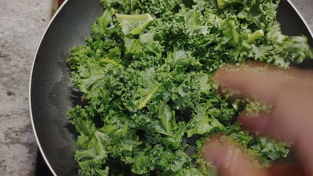 alt="Adding kale to fry"