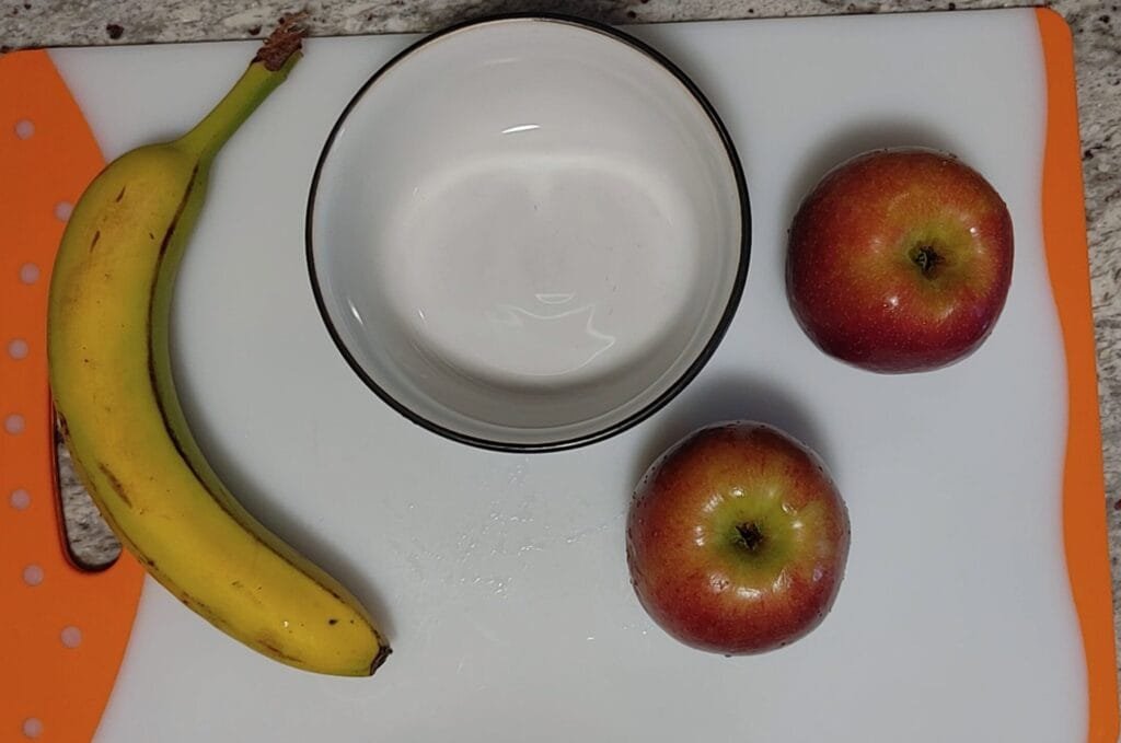 alt="Apples and Banana next to bowl"
