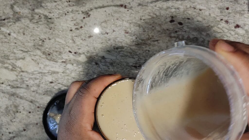 alt="Pouring Smoothie into glass"