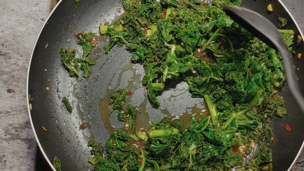 alt="Stirring the Kale stir fry"