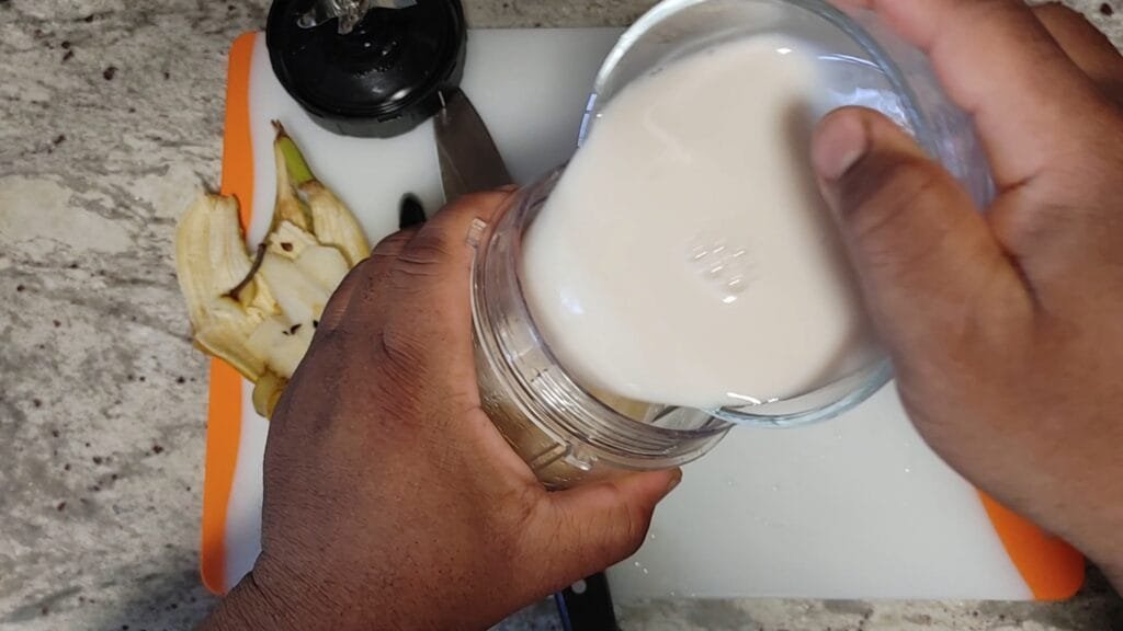 alt="Adding Almond milk to blender"