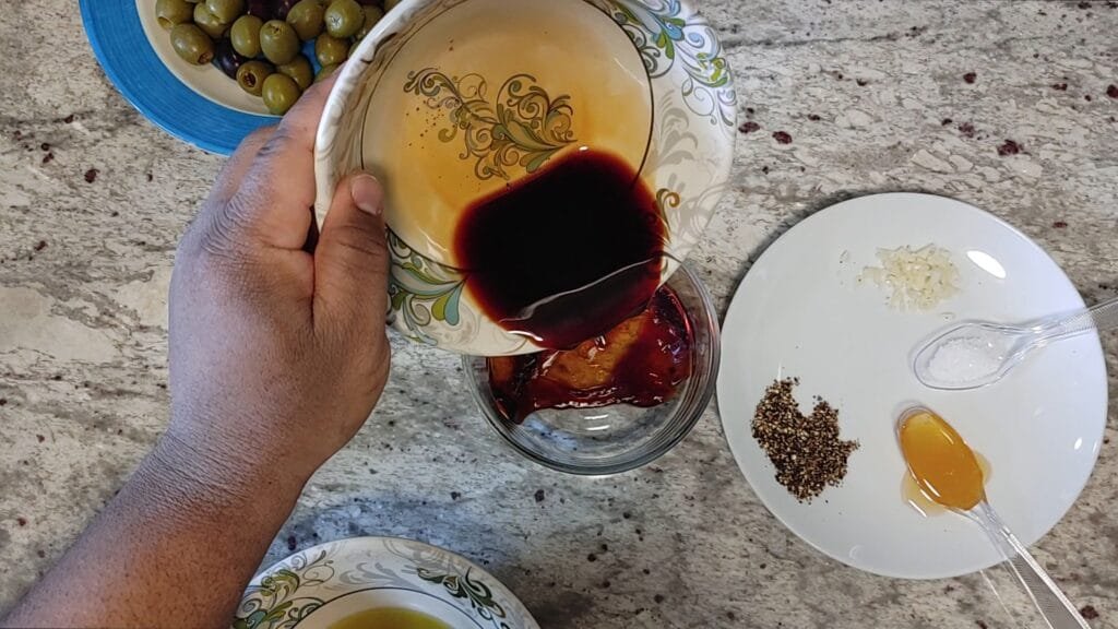 alt="Adding Balsamic Vinegar to bowl"