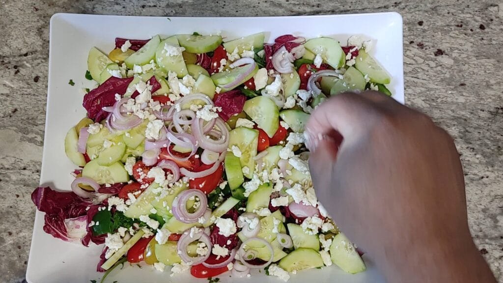 alt="Adding Feta Cheese crumbles"