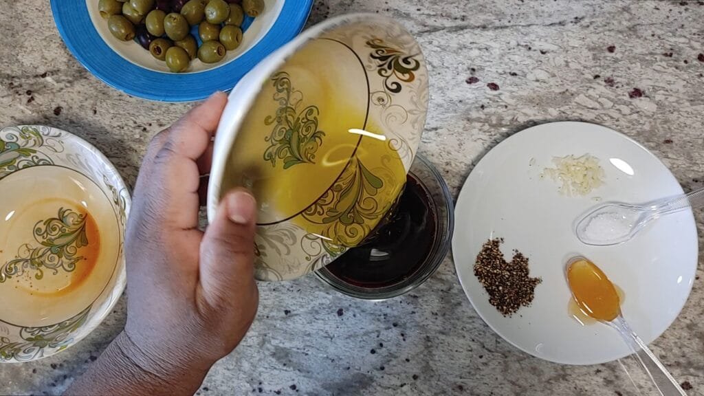 alt="Adding extra virgin Olive Oil to bowl"
