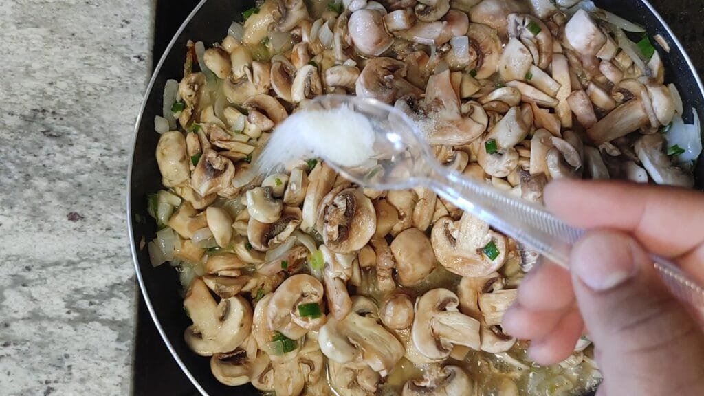 alt="Adding salt to frying pan"