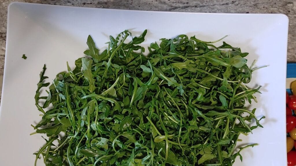 alt="Baby Arugula in a bowl"