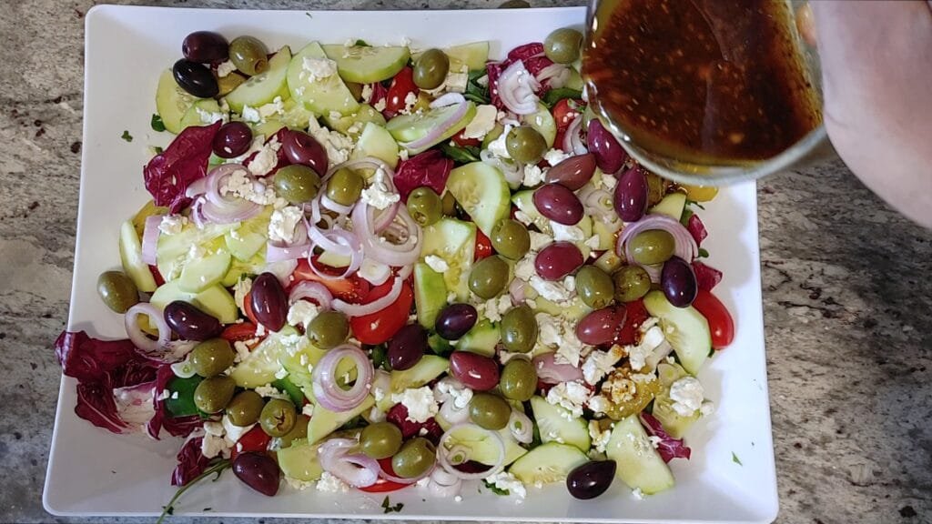 alt="Drizzling Vinaigrette over Salad"