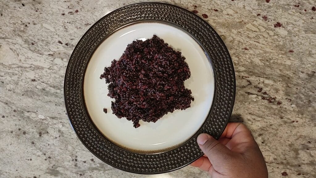 alt="Grabbing Plate of Black Rice"