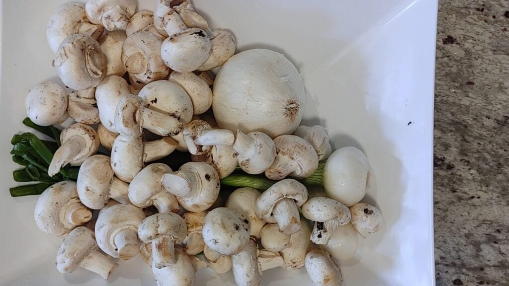 alt="Mushrooms garlic and spring onions"